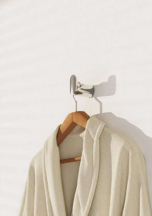 Stainless steel robe hook holding a white bathrobe on a wooden hanger