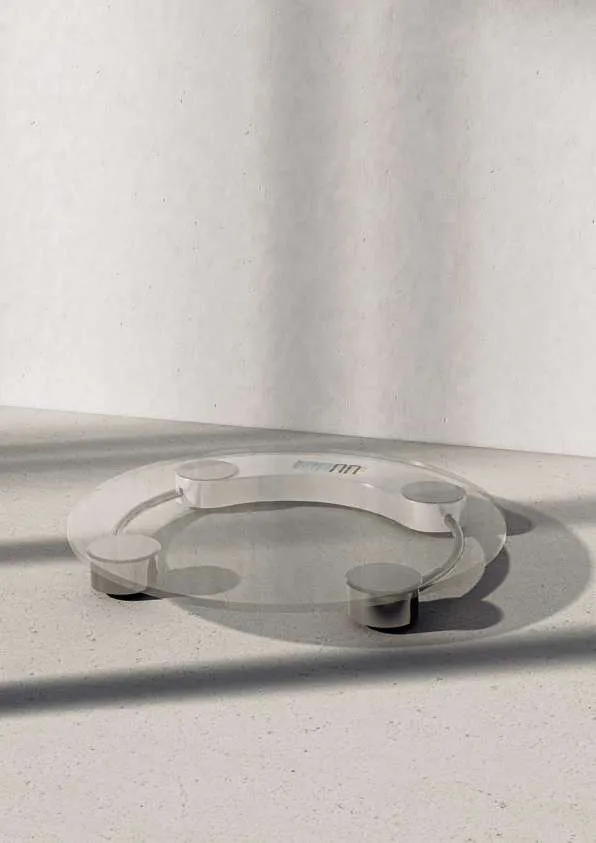 Tempered glass bathroom scale on a light floor
